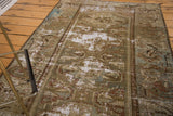 Hand-knotted distressed antique Malayer rug texture with moss greens and exposed foundation.