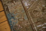 Distressed hand-knotted texture with exposed foundation in moss green, brown, and slate blue.