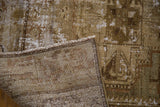 Distressed antique Malayer rug's pile revealing foundation and secure side in moss green and brown tones.