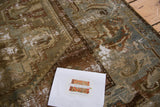 Distressed texture of the antique Malayer rug, foundation visible through moss greens and browns.