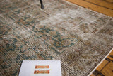 Visible foundation and faded teal Herati design on an antique Malayer rug.