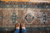 Distressed Karaja runner showcasing textured geometric brown, indigo, and ivory patterns.