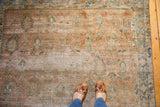 Faded dusty rose, peach apricot, and medium blue oversized motifs on a distressed Sivas rug.