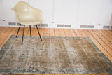 Distressed vintage Sivas rug showcasing muted blue geometric border and faded rose hues.