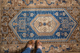 Geometric hexagonal medallion and brilliant cobalt blue field of a vintage Hamadan style rug.