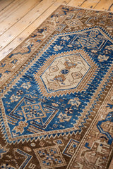 Ivory hexagonal medallion and geometric cobalt blue patterns on the vintage Hamadan rug.