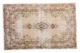 Distressed hand-knotted Kerman rug with ivory field, diminutive medallion, rococo borders.