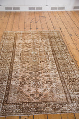 Decorative distressed gold and peach field with central medallion and bronze motifs.
