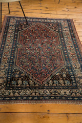 Secure fringe of a vintage Malayer rug, detailed with splayed floral border and repeating boteh.