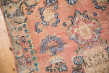 Hand knotted vintage Kerman rug section: coral field, blue florals, colorful border.