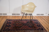 Vintage Afshar rug's geometric medallion in brick red, navy, coffee brown, and ivory.