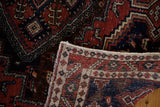 Hand-knotted foundation and geometric brick red, navy border of the vintage Persian Afshar rug.