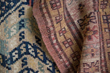Textured navy geometric motifs and banded red-gold pattern from vintage Caucasian carpet.