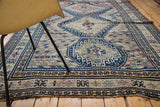 Navy blue and antique ivory geometric border with chevron lines on vintage Caucasian carpet.