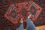 Vintage Malayer rug featuring intricate geometric triple medallion on blush rose field.