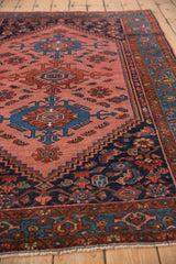 Intricate geometric blush rose field with cobalt and brick red motifs, joining a navy border.