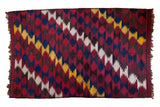 Hand knotted vintage Kilim carpet with dynamic zig-zag pattern in red, indigo, yellow, brown.