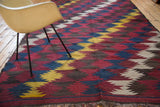Vintage Kilim rug's dynamic diagonal zig-zag motif in mustard, indigo, wine, taupe, brown.