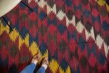 Energetic diagonal zig-zag vintage Kilim pattern in mustard, indigo, wine, and warm brown.