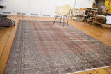 Distressed Oushak carpet with faded blush red, auburn, ivory, and slate blue border.