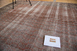 Faded blush red and ivory distressed Oushak carpet with subtle mir boteh texture.