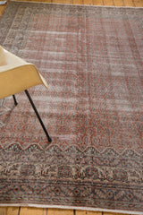 Distressed Oushak lower border and faded field with repeating mir boteh.