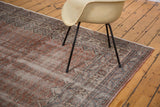 Distressed Oushak carpet edge detail showing secure fringe and faded mir boteh pattern.