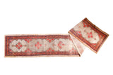 Distressed Persian camel hair Hamadan runner, blush and red geometric medallions on light field.