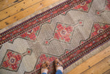 Distressed Persian runner: camel hair lattice field and colorful geometric motifs.