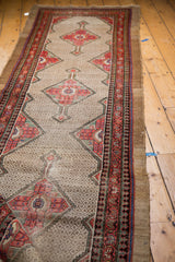 Distressed Hamadan runner with lattice field, rich blush, green, blue border motifs.