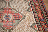 Distressed Hamadan rug's woven lattice field, bright blush, oxidized green, and sky blue border.