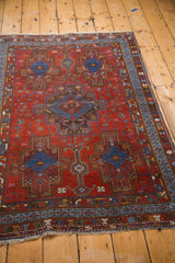 Ruby red ground, sapphire blue geometric Afshar rug patterns including tribal fish motifs.