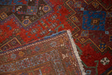 View of secure fringed edge, intricately hand-knotted foundation, and gem-tone patterned pile.