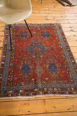 Hand-knotted fringe and geometric border patterns in ruby red, sapphire blue on Afshar rug.