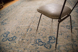 Vintage Tabriz carpet detail: tone-on-tone field with faded blue palmette motifs.