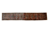 Vintage Lilihan rug runner displaying floral bouquets in navy and teal on a dusty blush ground.