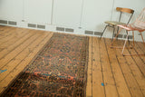 Angled perspective of a vintage Lilihan runner showing its field of repeating floral spray bouquets.