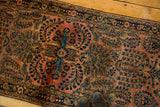 Intricate floral spray bouquets with navy and teal details on a dusty blush vintage rug runner.