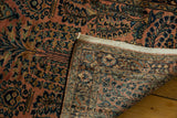 A folded corner on the vintage Lilihan runner displays its floral pile and hand-knotted back.
