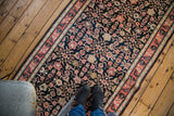 Navy, coral, and antique ivory Herati and Henna plant motifs on this antique Karabagh runner.