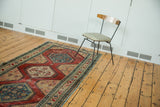 Antique North West Persian runner with cherry red field, sky blue medallions, and diverse borders.