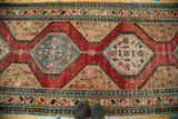 Antique North West Persian runner with playful alternating teal and ivory medallion backgrounds.