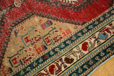 Antique North West Persian runner: beige medallion, patterned borders, cherry red, sky blue.