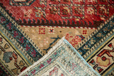 Antique North West Persian rug's hand-knotted foundation and red, ivory, blue geometric border.