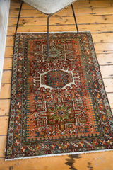 Rectilinear medallion and Laleh Abassi pattern on a vintage Karaja rug in rust, green, and blue.