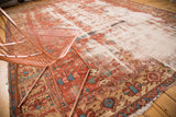 Distressed antique Heriz carpet with heavy wear and exposed ivory foundation.