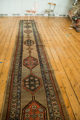 Alternating charcoal and rust geometric medallions with patterned borders on a vintage Serab runner.