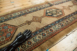 Detail of hand-knotted Serab runner with blue, rust, and charcoal geometric border patterns.