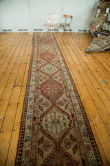High-angle view of a vintage Persian Serab runner showing its full length and dynamic medallion pattern.