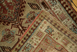 Folded corner of a vintage Serab runner showing the hand-knotted pile and latch hook border.